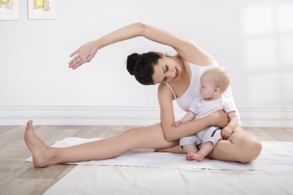 Healthy mother and baby making gymnastics